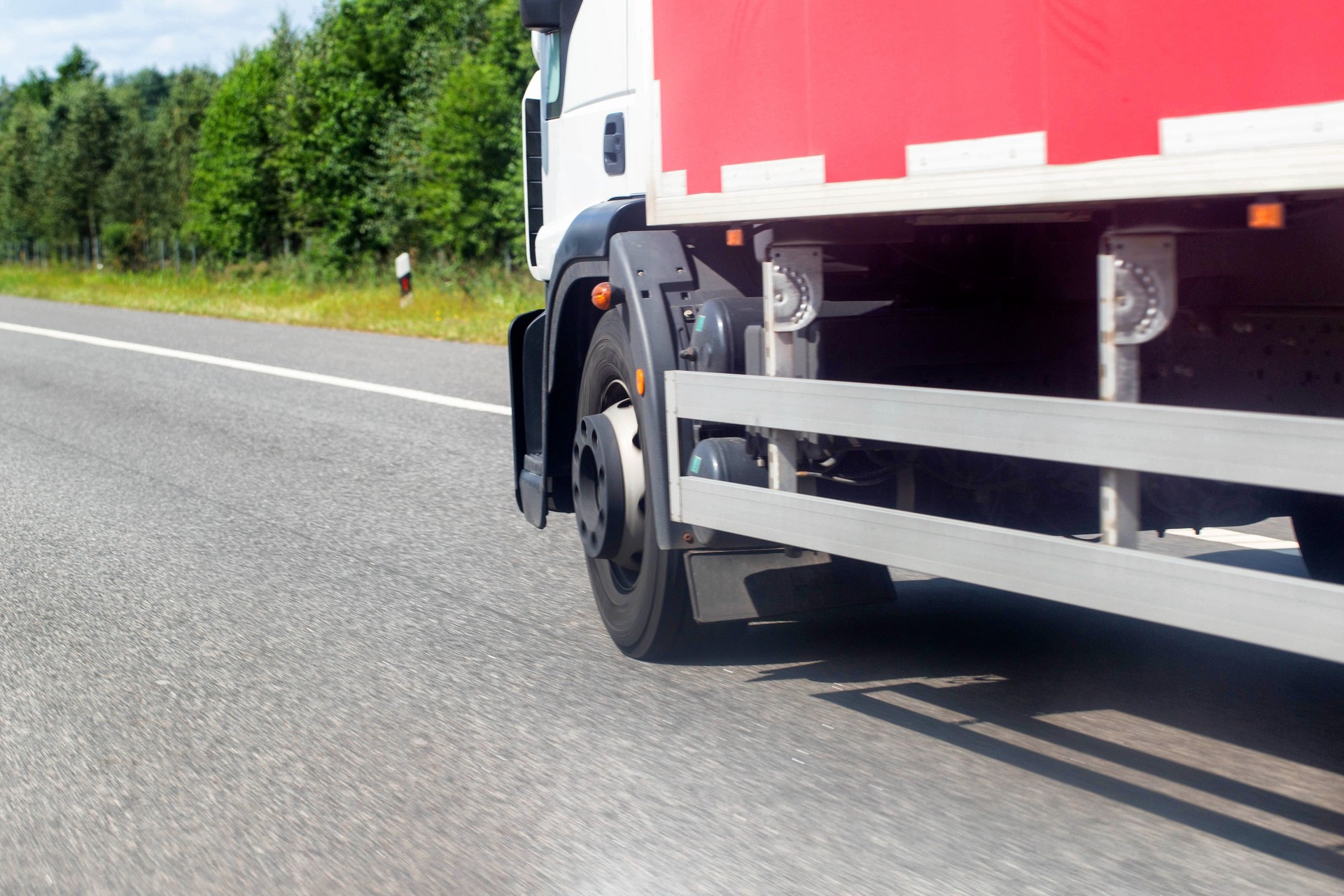 Specialized trucks with a carrying capacity of up to 5 tons transport cargo along the highway in the summer, industry. Copy space for text